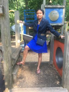 Briana Booker wears Kwame Baah handcrafted sandals at the playground.