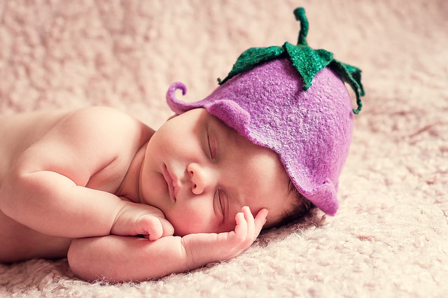 Newborn Baby sleeping with hat on