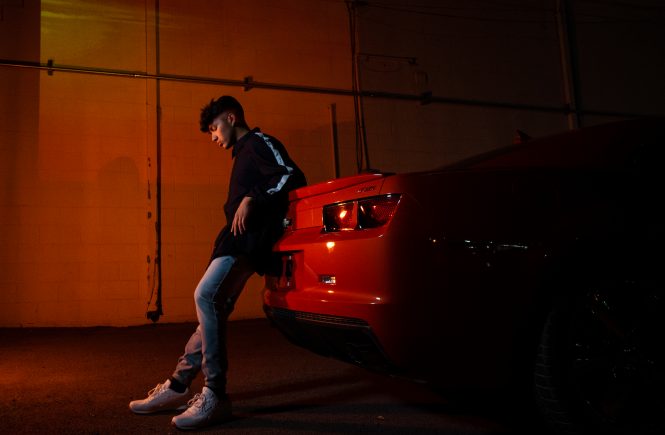 Roman Rouge standing near a car