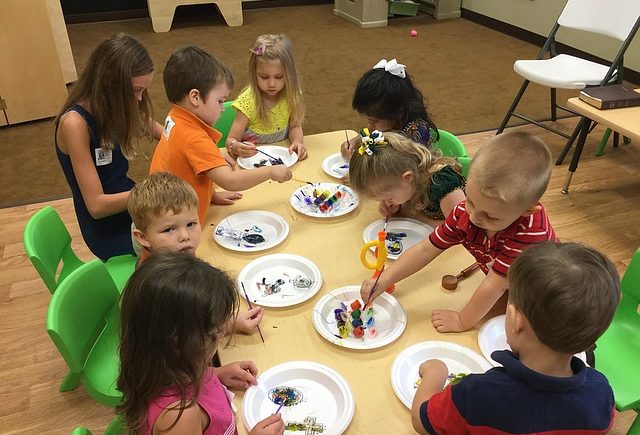 Pre-k students playing at a table